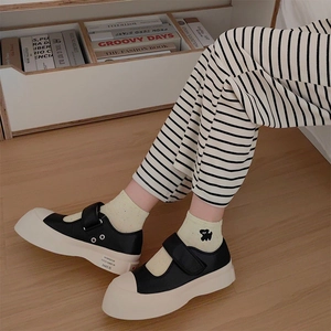 Retro Mary Jane platform shoes with black leather finish and creamy white chunky soles