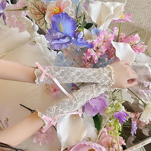 Detailed lace texture and pink satin bow on cream Lolita style sun protection sleeves