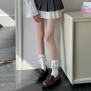 White Lolita calf socks with double silk bows paired with brown leather loafers