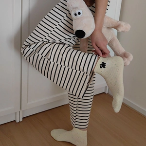 Close-up of cute dog embroidery on polka dot socks with a black and white striped outfit