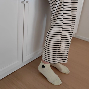 Close-up of yellow cotton socks featuring a cute dog embroidery for a casual home style