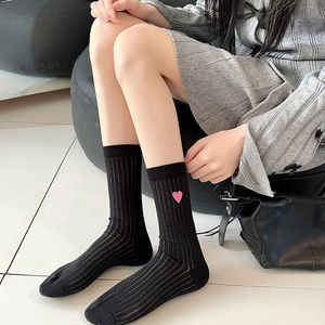 Close-up of black mid-calf socks with pink heart embroidery and vertical ribbed texture