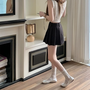 Close-up of sweet Lolita lace ruffled socks styled with a pleated skirt and white flat shoes