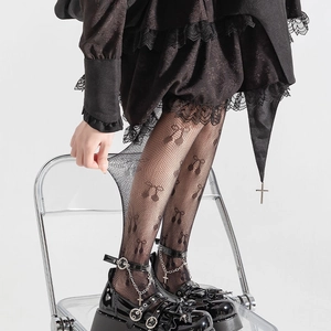 Détail de collants résille noirs extensibles avec motifs de nœuds élégants et texture dentelle