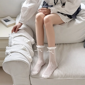 White lace mesh knee high socks with bow detail and heart hollow knit pattern