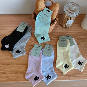 Detail shot of multi-color cotton socks set with cute small bear embroidery accents