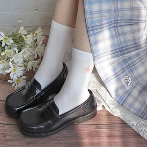 White JK style calf socks with pink cherry blossom embroidery and school skirt