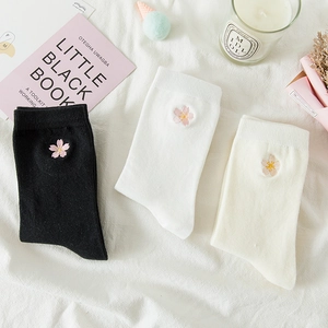 Detail of soft cotton crew socks featuring delicate pink flower embroidery on the side