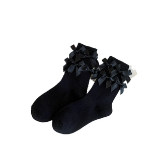 Sweet Lolita style black knee high socks featuring elegant satin double bows on the cuffs
