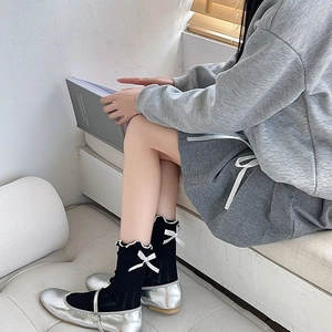 Japanese style black mesh socks with white frills and satin bow for a balletcore aesthetic