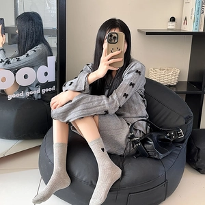 Detail of sweet heart embroidery on gray ribbed cotton crew socks for women