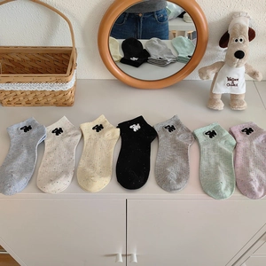 Close-up of low-cut cotton socks featuring cute puppy embroidery in seven pastel colors