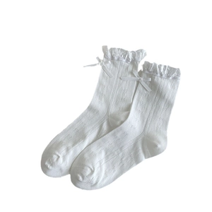 White JK style calf socks with lace trim, bow detailing, and floral mesh pattern