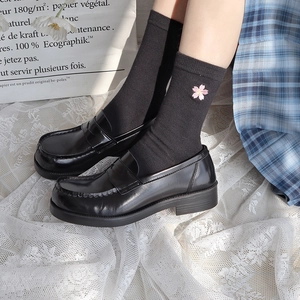 White JK mid-calf socks with pink cherry blossom embroidery paired with black loafers