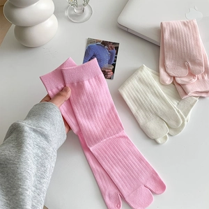 Detail of colorful split-toe socks with vertical ribbed texture and cotton blend fabric