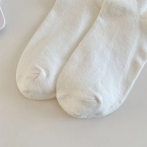 Detailed close-up showing the smooth toe seam and high-quality white knit cotton fabric