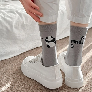 Gros plan sur des chaussettes grises en coton avec motif panda et bord-côte élastique