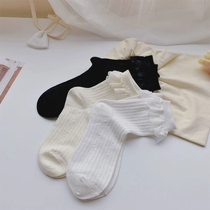 Detailansicht von drei Paar gerippten Baumwollsocken mit zarter Spitze in Schwarz und Weiß