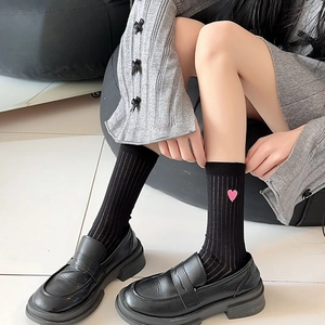 Women's black crew socks with pink heart embroidery and vertical ribbed knit texture