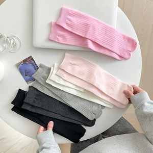 Mid-calf split-toe socks in various colors with vertical ribbed texture knit