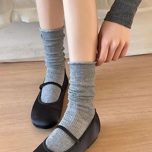 Breathable gray slouch socks for women with vertical ribbed texture and Mary Jane shoes