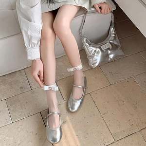 Detail of silver Mary Jane flats with white satin bow and pink gemstone embellishment