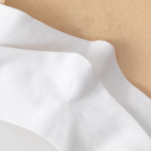 Detail of white rib-knit Lolita socks with delicate cotton texture and soft butterfly straps