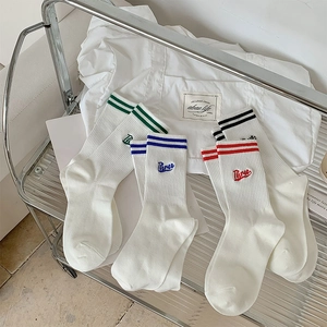 Detailed embroidery of letter 'Three' on cotton ribbed socks with double stripes