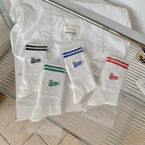 Detailed set of four striped cotton socks with Three embroidery in minimalist display