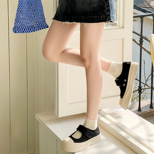Detail view of black canvas Mary Janes with platform soles and velcro straps for women
