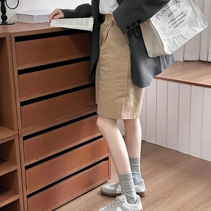 Minimalist grey crew socks paired with khaki utility shorts and stylish sneakers