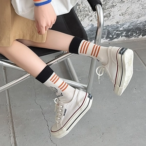 Artistic mid-calf socks featuring orange stripes and brain pattern with canvas shoes