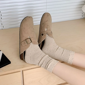 Women's beige speckled knit crew socks styled with brown clogs in a Japanese fashion look