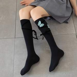 Japanese Lolita style black knee-high socks with blue butterfly embroidery and ribbon ties