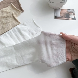 Close-up of fine ribbed texture on breathable cotton socks showing elastic stretch