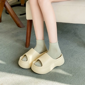 Beige EVA platform slides in bread style, shown on foot with socks for a cozy look