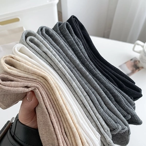 Close-up of six assorted solid color ribbed crew socks in neutral tones for women