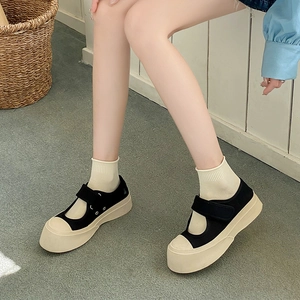 Black and white canvas Mary Jane platform shoes with Velcro straps and knit socks