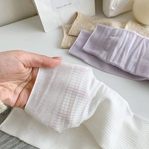 Close-up of high-elasticity ribbed cotton socks in soft pastel colors and fine knit texture