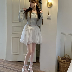 Detail of sweet grey knit top with ribbon bow and white layered mesh tutu skirt