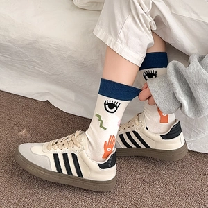Artistic hand-drawn graphic crew socks with pop art eyes and abstract pattern detail