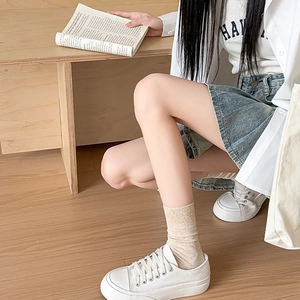 Detailed knit texture of light beige ribbed crew socks in a cozy lifestyle setting