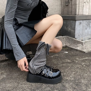 Punk platform Mary Janes with grey zipper leg warmers and heart buckles on city street