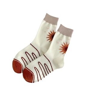 Artistic hand-drawn mid-calf cotton socks with abstract sun patterns and ribbed cuffs