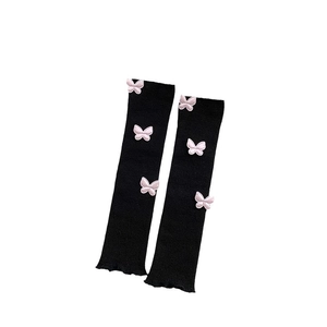 Japanese style black ribbed leg warmers with pink butterfly accents and ruffled edges