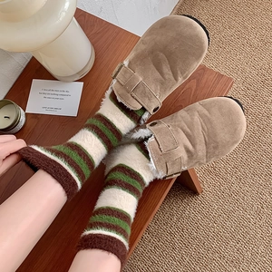 Détail de chaussettes rayées en fausse fourrure et sabots Boston doublés de polaire