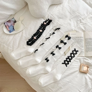 Japanese style Lolita white knee high socks with black bows and lace details