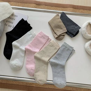 Detailed knit texture of rib-cuff crew socks in six assorted colors with speckle yarn