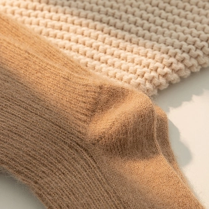 Close-up of thick ribbed camel thermal socks showing soft plush texture for winter