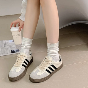Close-up of retro leather sneakers paired with vintage speckled knit crew socks